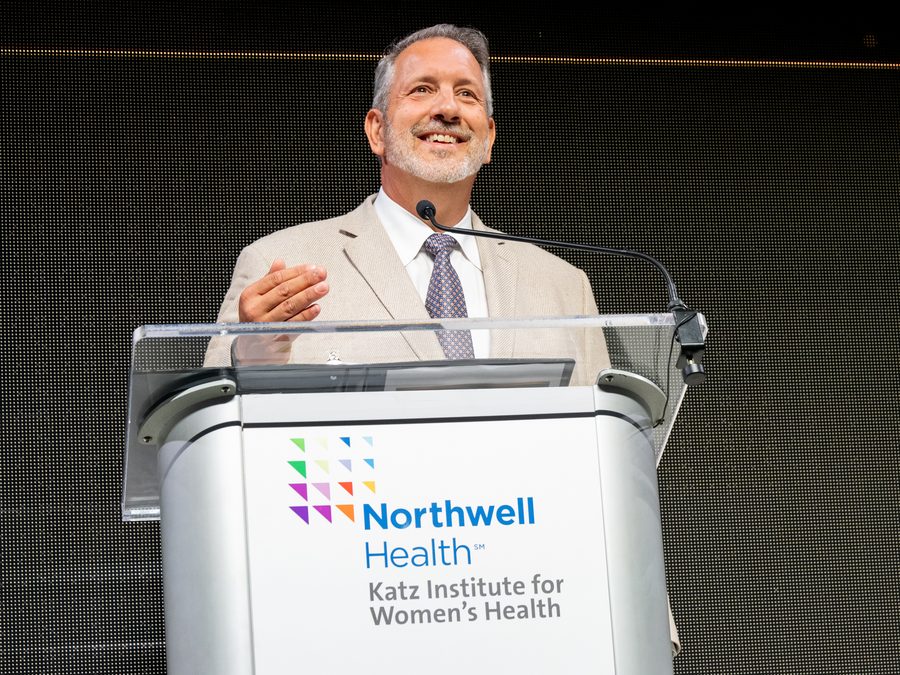 Frank smiling at the podium during his talk